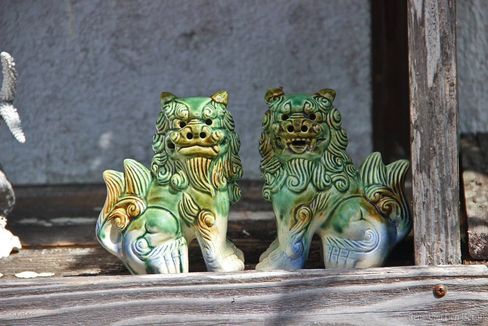 Two Shisa. The one with open mouth keeps bad spirits away. The one with closed mouth keeps the good spirits in. Kabira, Ishigaki Island.
